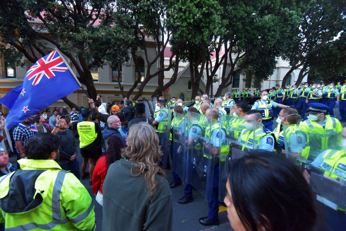 One protester has been arrested for driving a car towards a line of police officers.