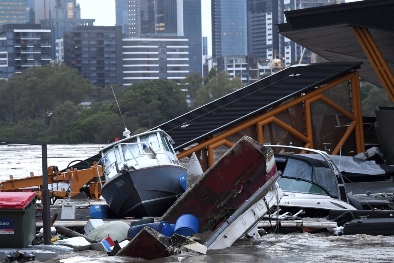 Boats and other debris are seen washed into the Milton ferry terminal in Brisbane as floodwaters kept rising on Monday.