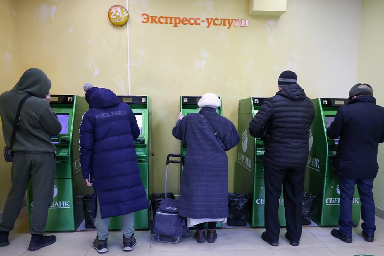 Russians are lining up to withdraw their savings as the Ruble plunges in response to western sanctions.