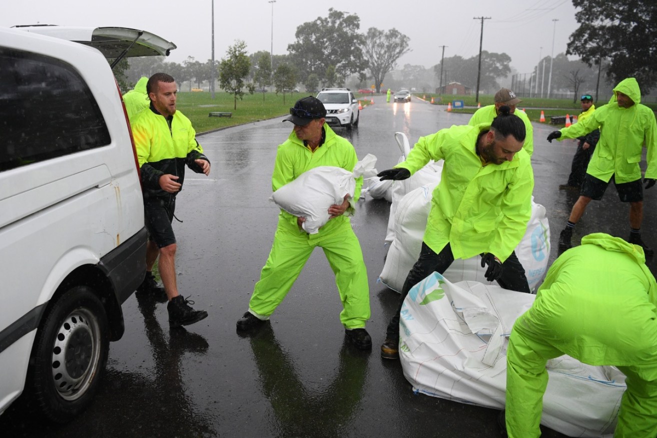 Penrith City Council workers load sand bags into residents' cars ahead of Thursday's expected life-threatening weather.