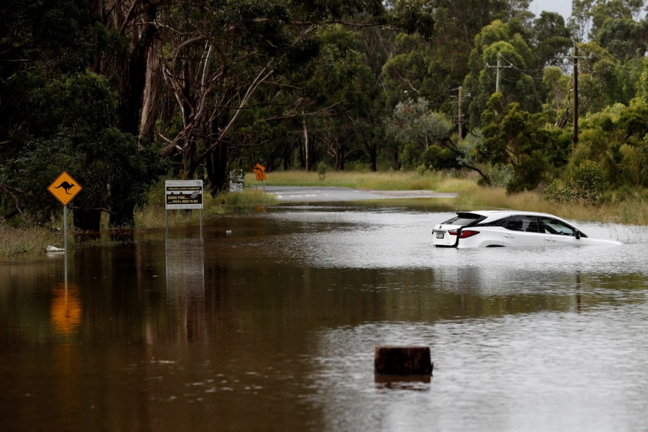 A car floats in floodwaters on the Hawkesbury River, where there are still fears for further rises.