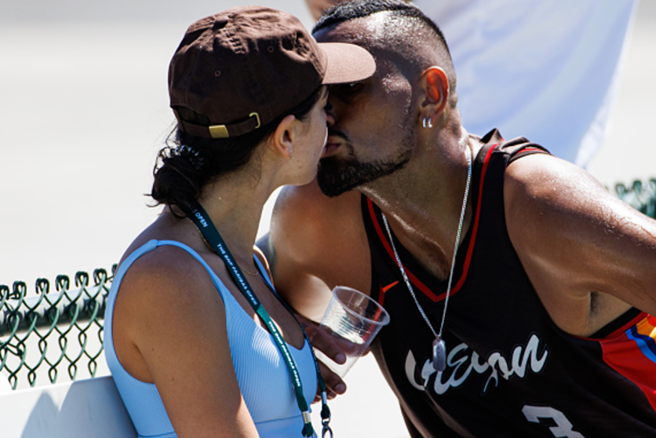 Nick Kyrgios' mind wasn't entirely on tennis as he plants a kiss girlfriend Costeen Hatzi at Indian Wells.<i>Photo: Getty</i>
