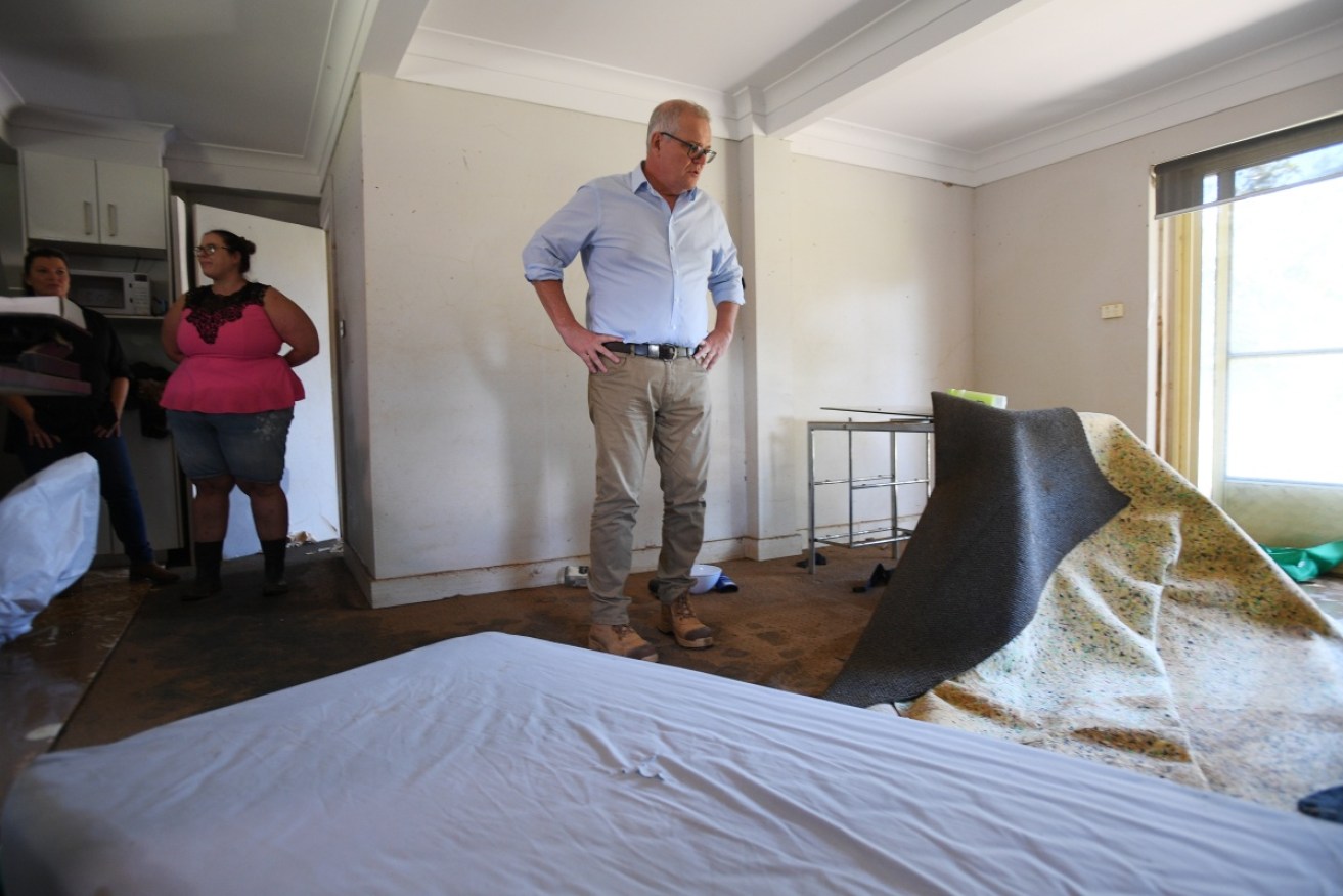Prime Minister Scott Morrison in the flood affected property of Darren Vaughan and Chloe Konispoliatis.