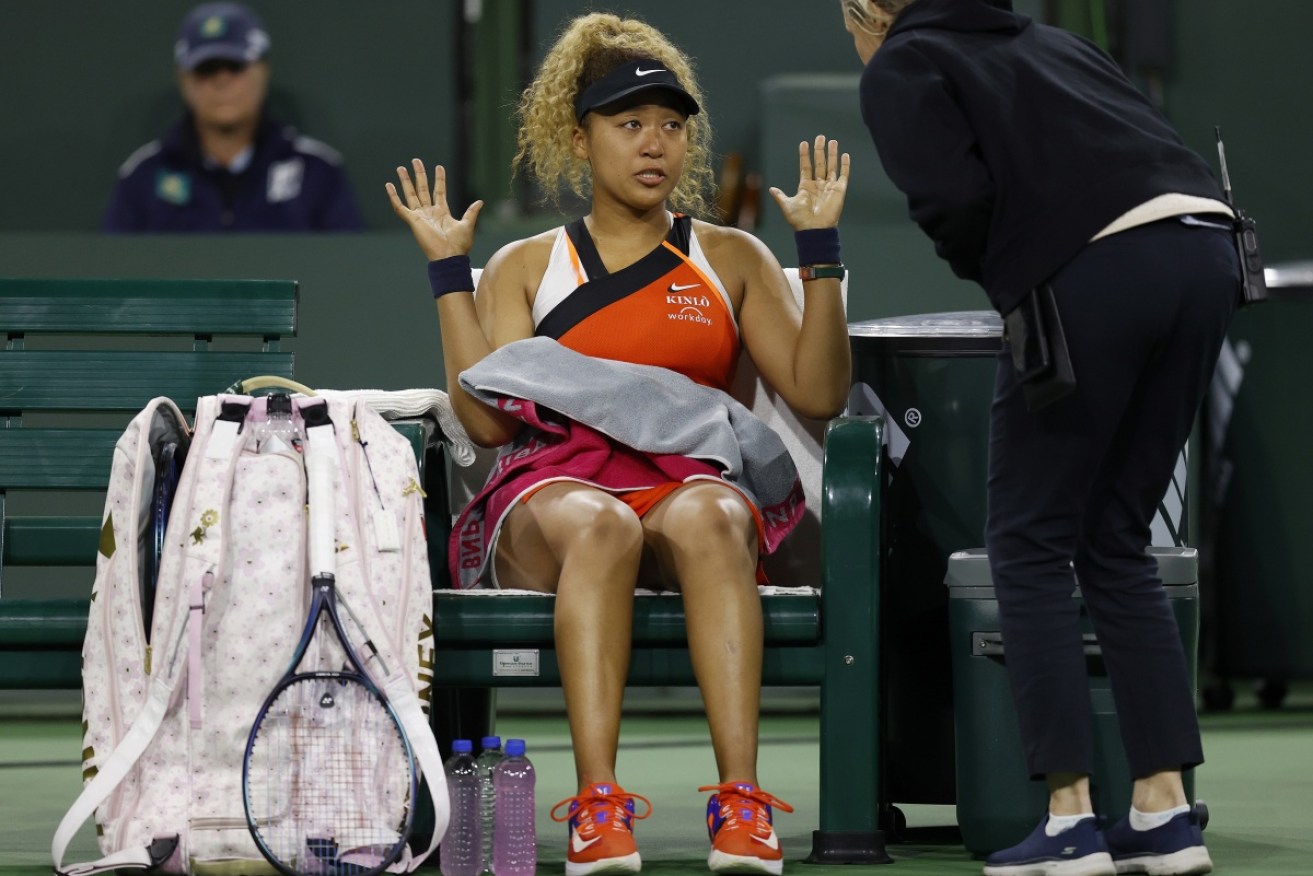An upset Naomi Osaka speaks to supervisor Claire Wood during her second-round loss at Indian Wells. 