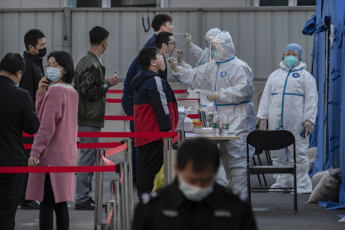 The Chinese capital began mass testing people in one of its 16 districts where most of the new cases have been found.
