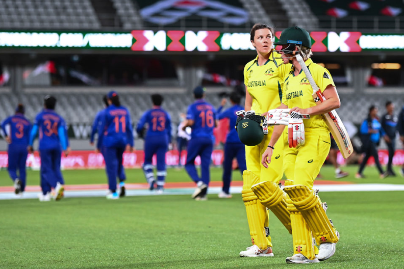 Tahlia McGrath (L) and Beth Mooney leave the field after sealing Australia's thrilling three-run victory over India.<i>Photo: Getty</i>