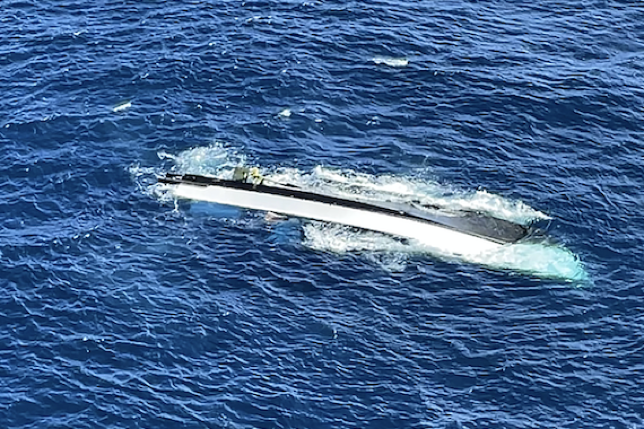 The semi-submerged NZ charter fishing boat Enchanter, which sank on Sunday with 10 people on board.