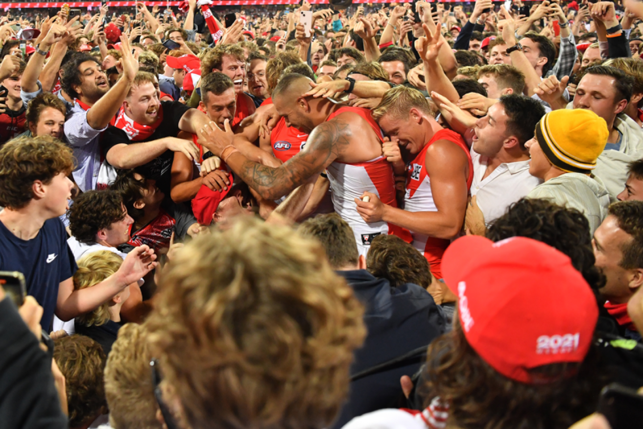 Buddy Franklin is mobbed seconds after his history-making 1000th goal.<i>Photo: AAP</i>