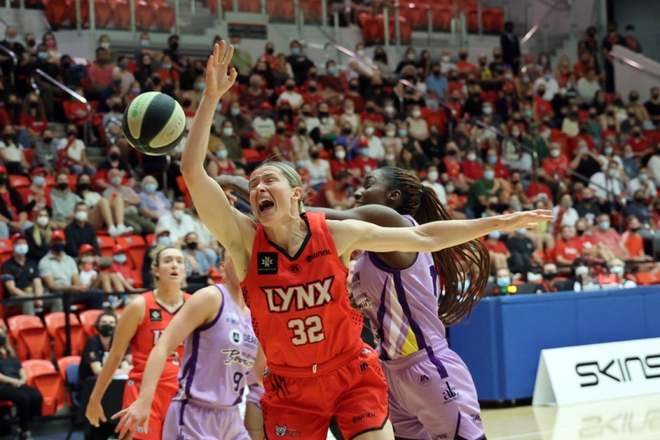 Perth Lynx's Sami Whitcomb and Melbourne's Ezi Magbegor fight for possession in Perth on Wednesday night.