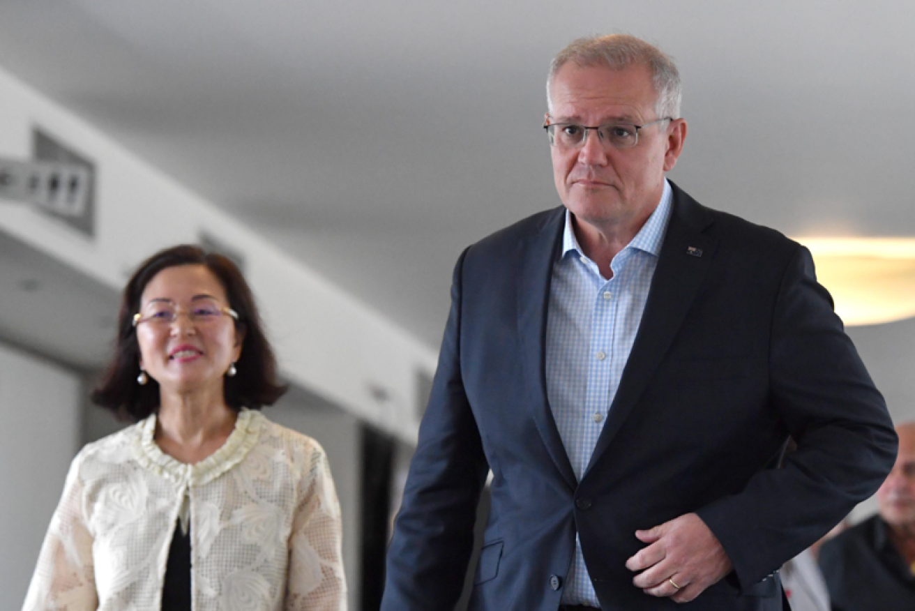 A stone-faced Scott Morrison leaves the church with Chisholm candidate Gladys Liu after things didn't go as planned.