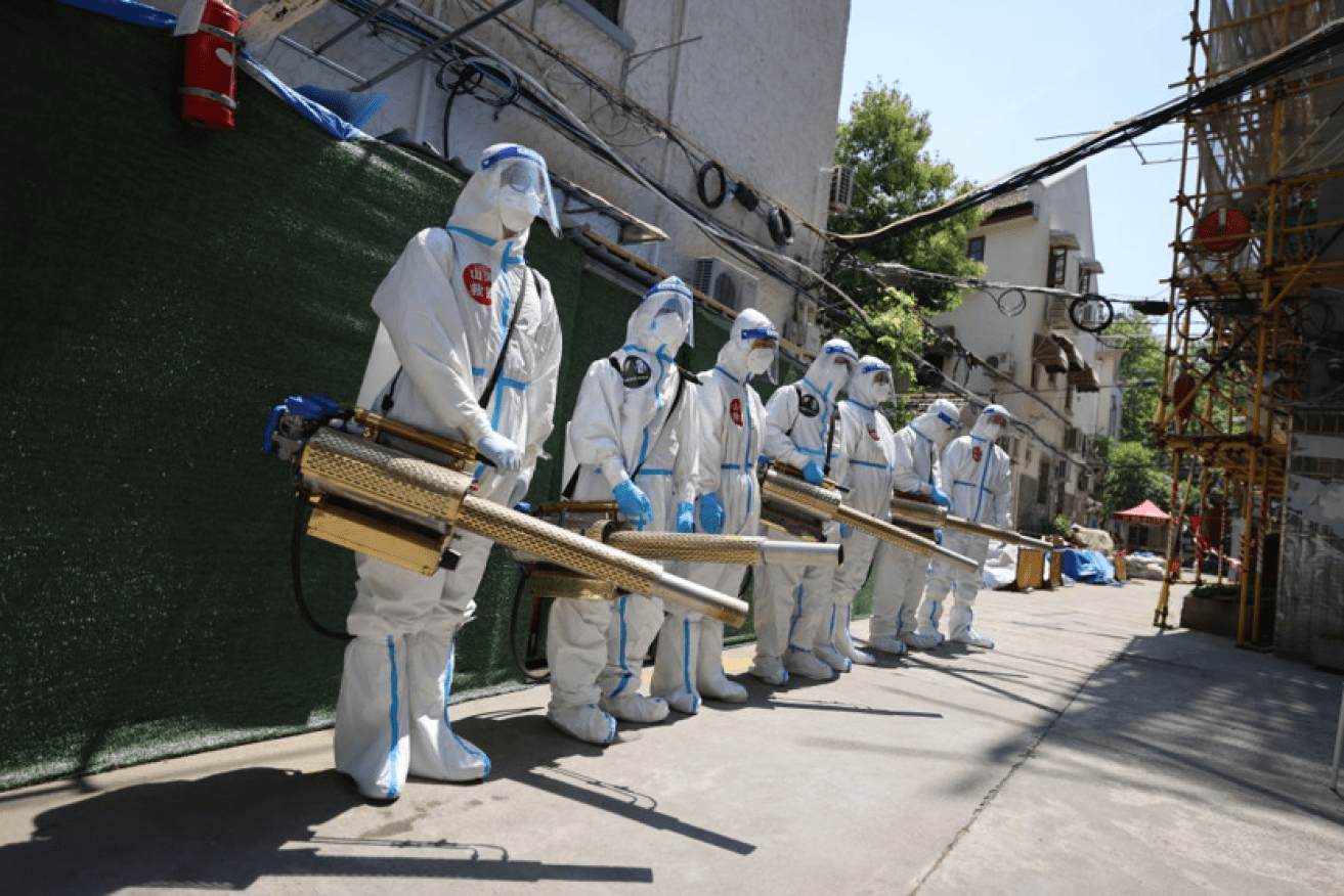 An army of moon-suited  workers armed with disinfectant sprayers are everywhere in Shanghai. <i>Photo: Getty</i>