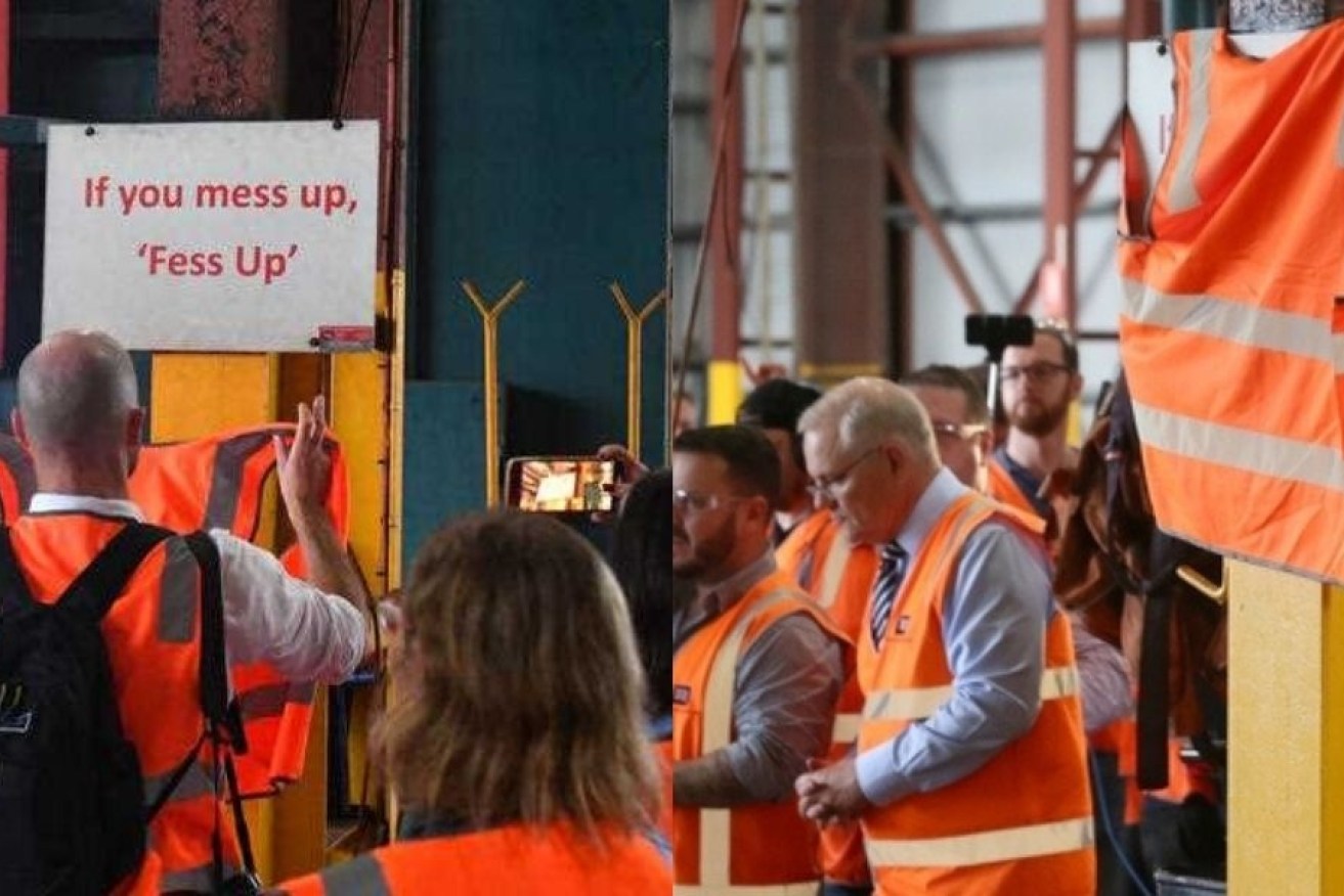One of the signs is hastily covered at the Townsville factory on Tuesday.