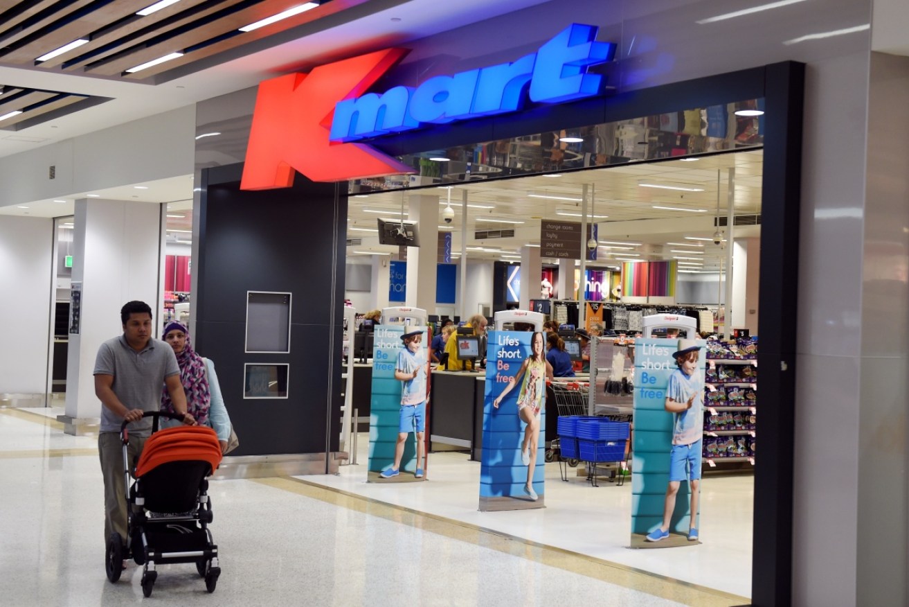 Kmart displays signs warning of its use of facial recognition technology at store entrances.