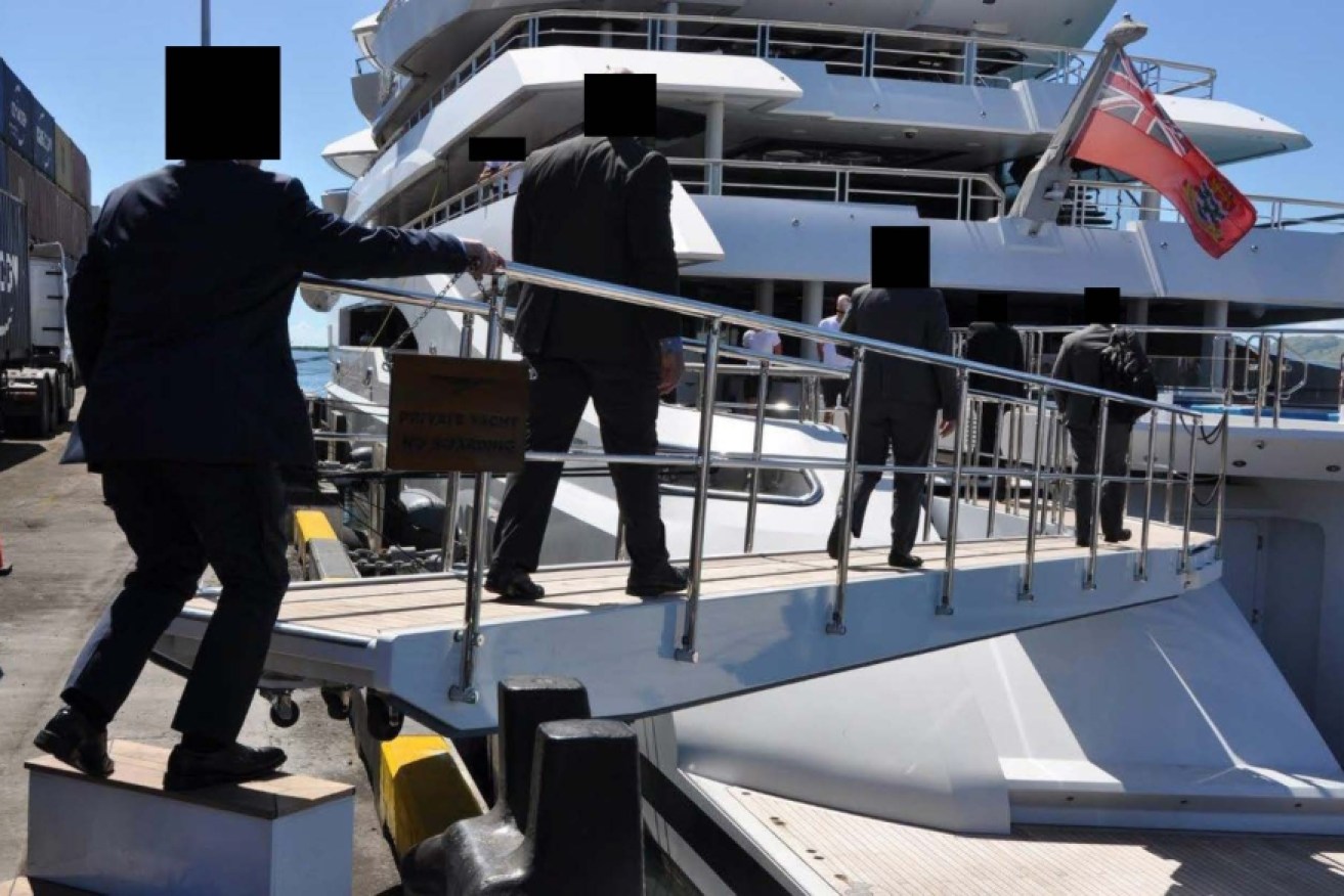 Authorities board the yacht in port in Fiji.