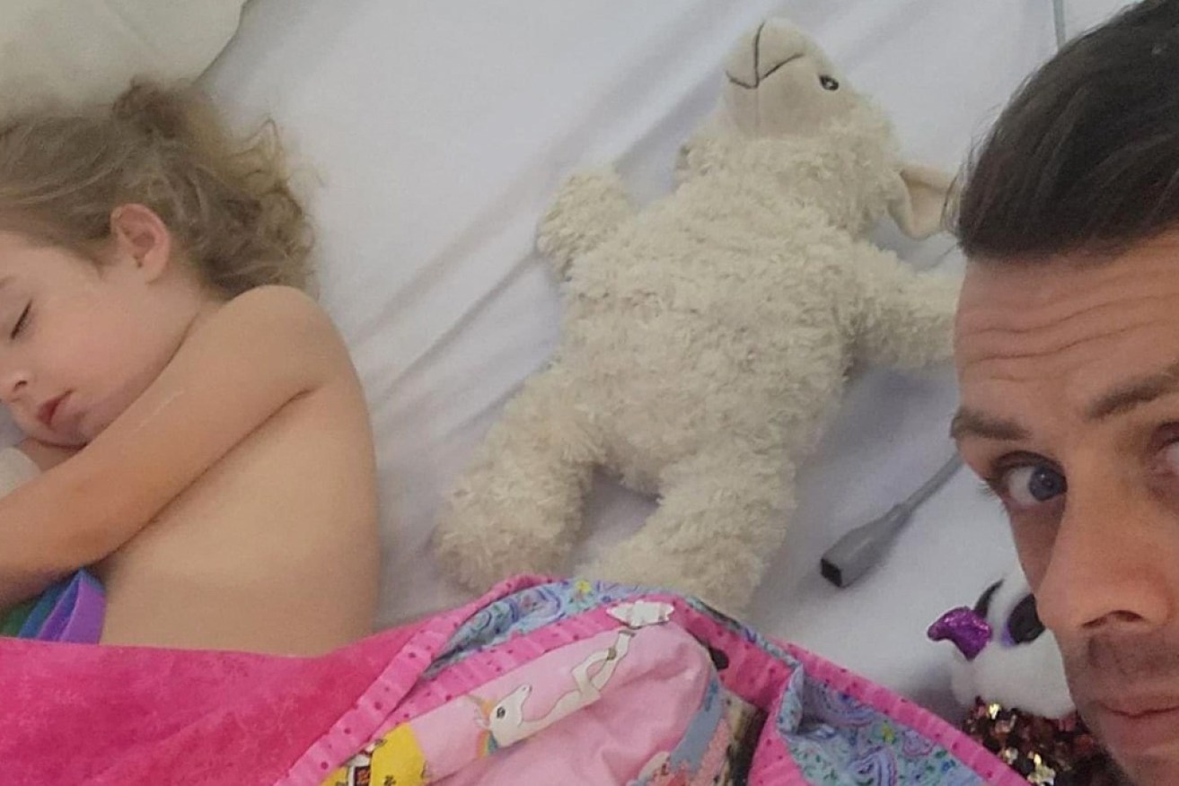 Three-year-old Nevaeh in hospital, with father Shane Austin.