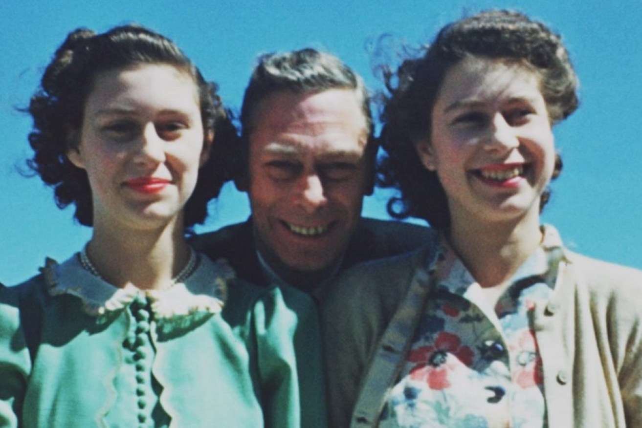 Elizabeth, right, poses with her sister Margaret and their father George VI in a previously unseen photo from the documentary. 
