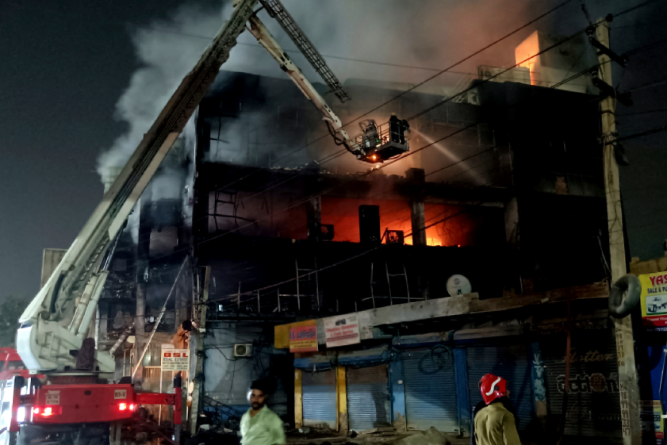 Fireman battle to douse the blaze that claimed the lives of at least 27 people. <i>Photo: Twitter/Abdul Rahman</i> 