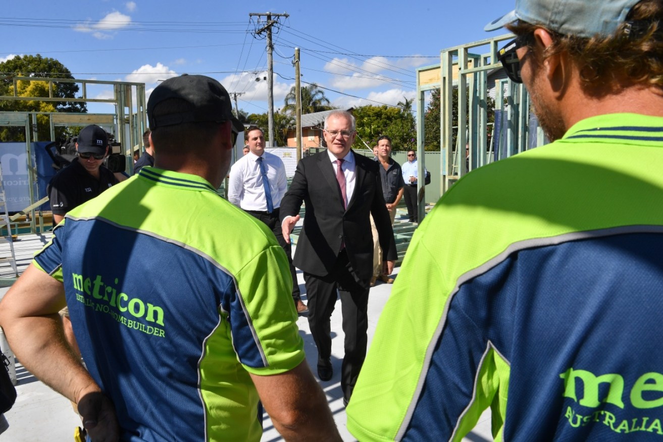 Metricon staff talk to Prime Minister Scott Morrison at a site in Brisbane.