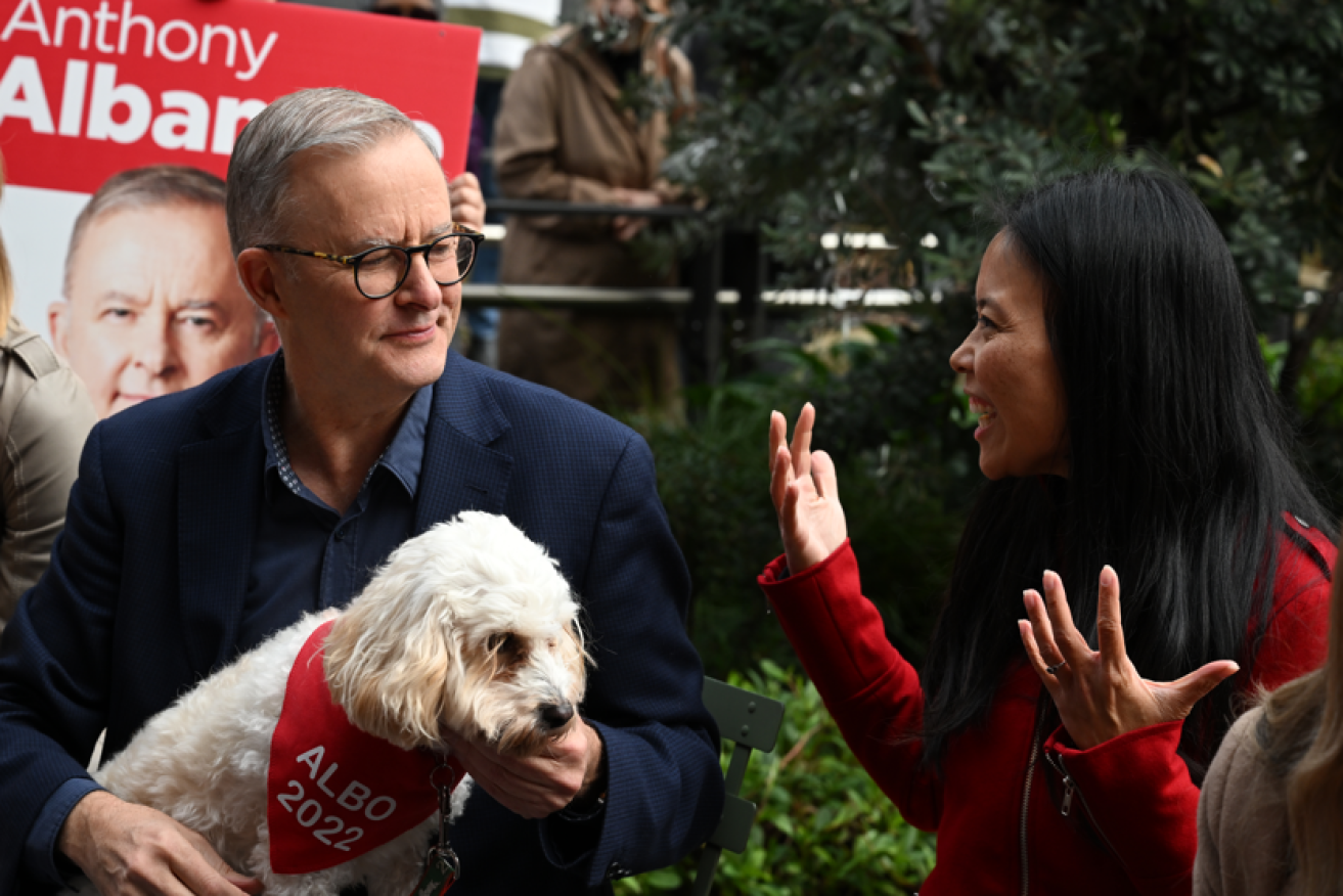 Incoming Prime Minister Anthony Albanese and his dog Toto meet the newly elected Labor member for Reid, Sally Sitou. 