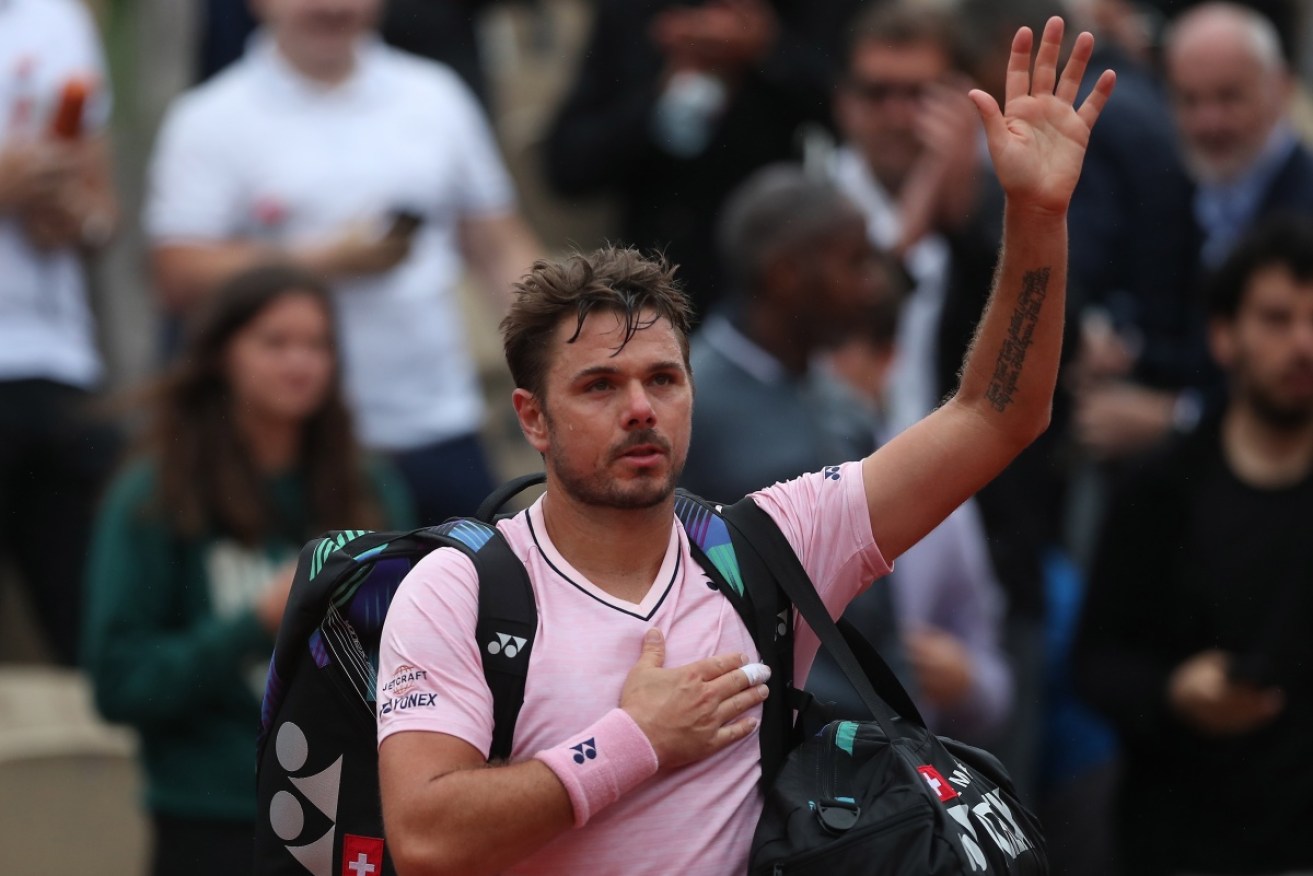 Stan Wawrinka waves goodbye to Roland Garros 2022 after a first-round loss to Corentin Moutet. 