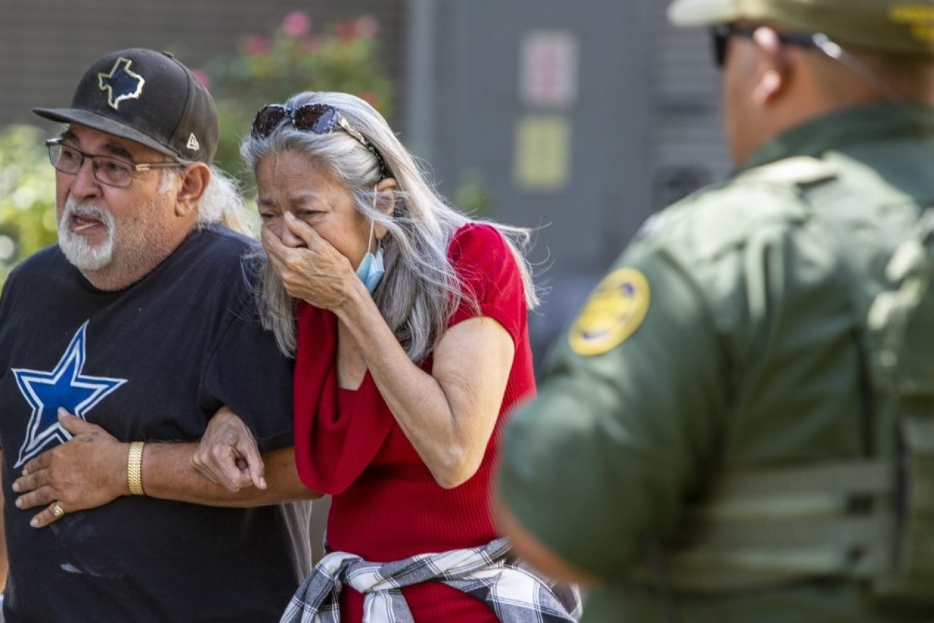 A woman cries as she leaves the Uvalde Civic Centre after Tuesday's deadly school shooting.