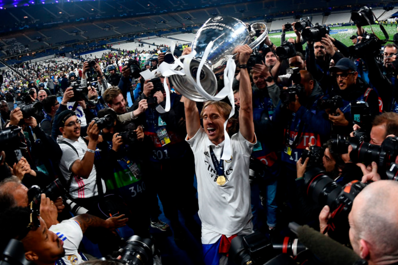 Luka Modric of Real Madrid raises the trophy in triumph after putting Liverpool to the sword at Stade de France. <i>Photo: Getty</i>