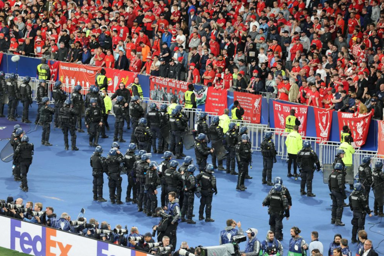 Riot cops battled Liverpool supporters outside the stadium, as more police confronted fans inside. 