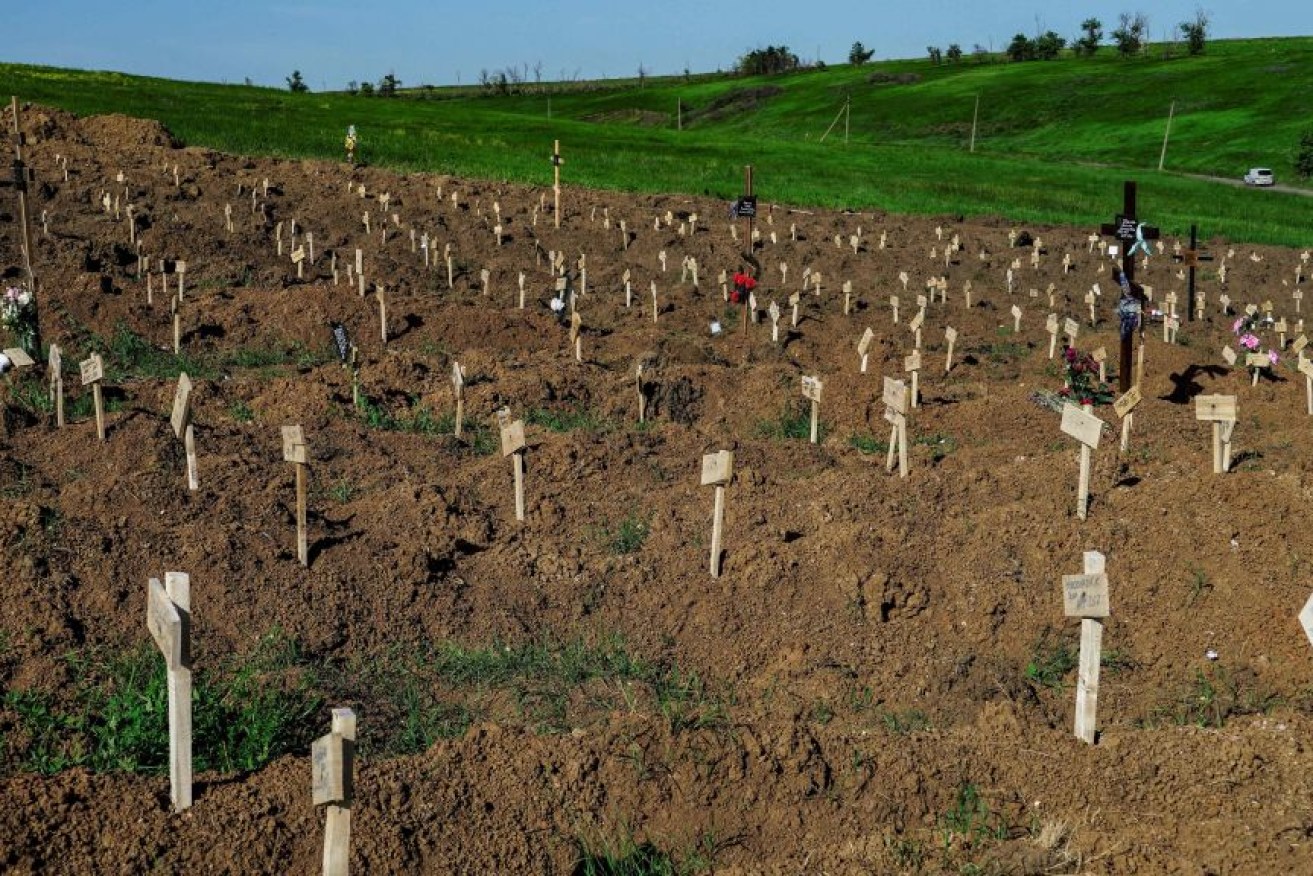 Fresh graves carpet a makeshift cemetery in the devastated city of Mariupol, where disease is now a more ruthless killer than Russian invaders. <i>Photo:  Getty</i>