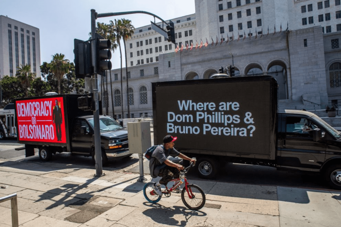 The disappearance and feared murders of the crusading journalist and his Indigenous associate is prompting protests around the world, including these Los Angeles signs. <i>Photo: Getty</i>