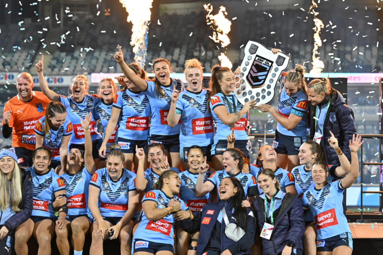 NSW women erupt in a delirium of delight after winning the series.