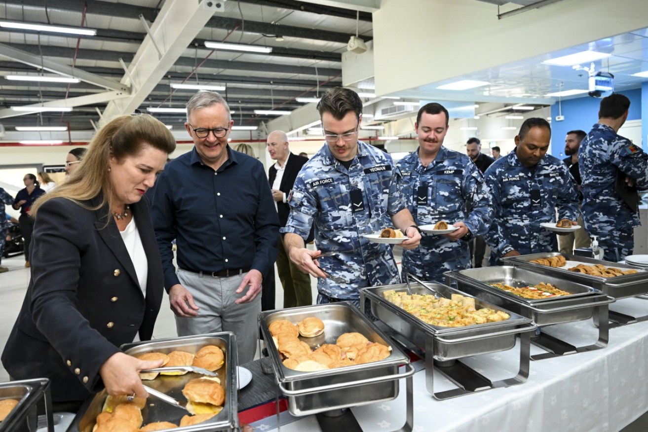 Mr Albanese lines up with ADF members at Camp Baird for breakfast on Monday.