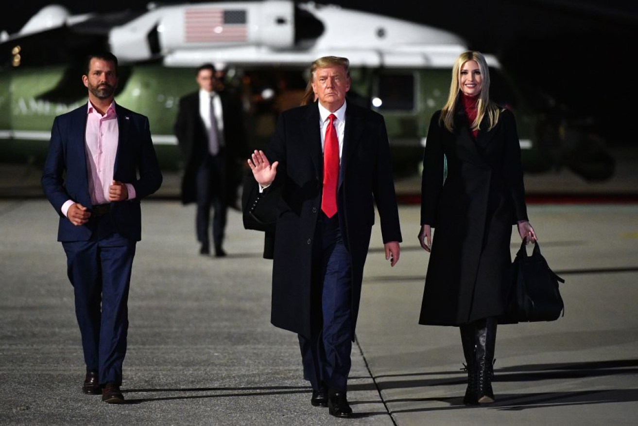 Donald Trump – flanked by son Donald Jnr  and daughter Ivanka – board Air Force One on January 4, 2020.