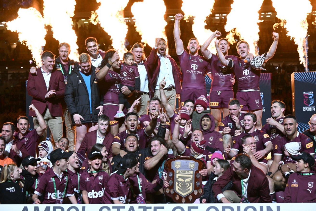 The Maroons squad celebrates its victory in the State of Origin decider with family.