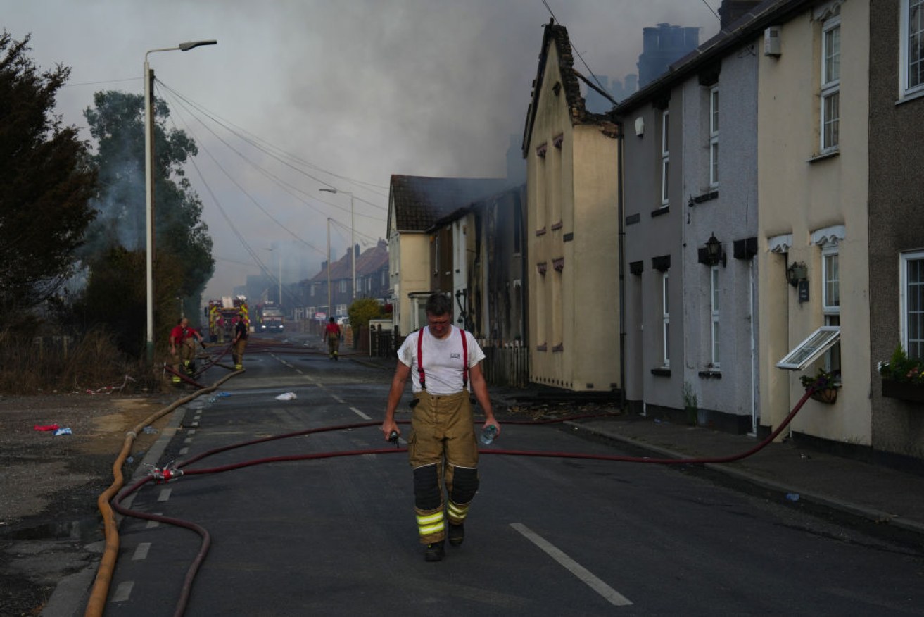 A weary firemen trudges from July's grass fires in  Wennington, England, where drought and extreme temperatures sparked a series of raging blazes. <i>Photo: Getty</i>