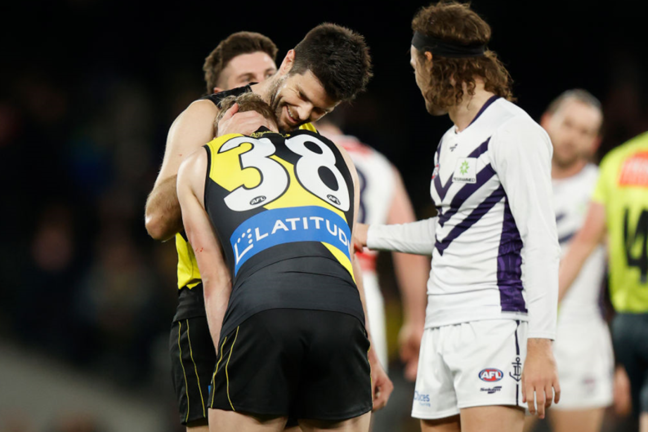 Fourth-gamer Noah Cumberland of the Tigers is consoled by teammate Trent Cotchin after blowing Richmond's chance to break the tie and snatch victory in the final seconds. <i>Photo: Getty</i>