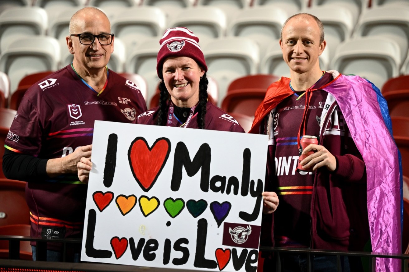 Manly fans show their support for the inclusion-themed jersey at the NRL clash against the Roosters.