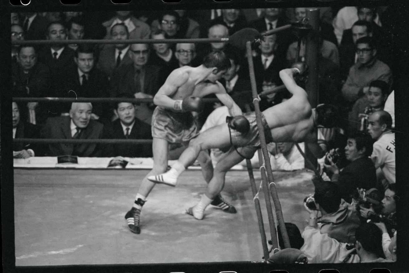 Australia's Johnny Famechon knocks Japanese challenger Fighting Harada out of the ring during a 1970 bout.