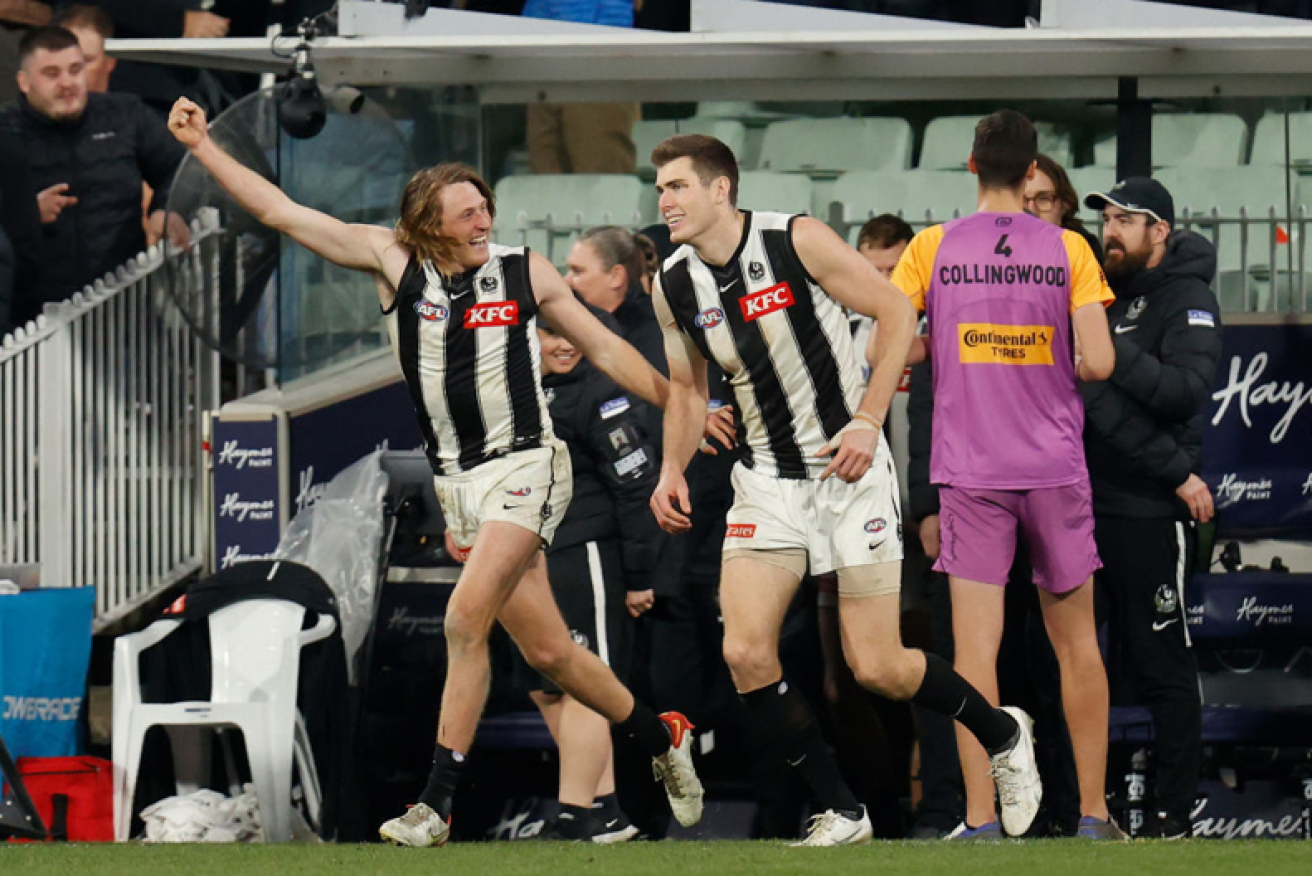 Nathan Murphy (left) and Mason Cox of the Magpies celebrate as the siren adds another win to the team's 10-straight tally. <i>Photo: Getty</i>
