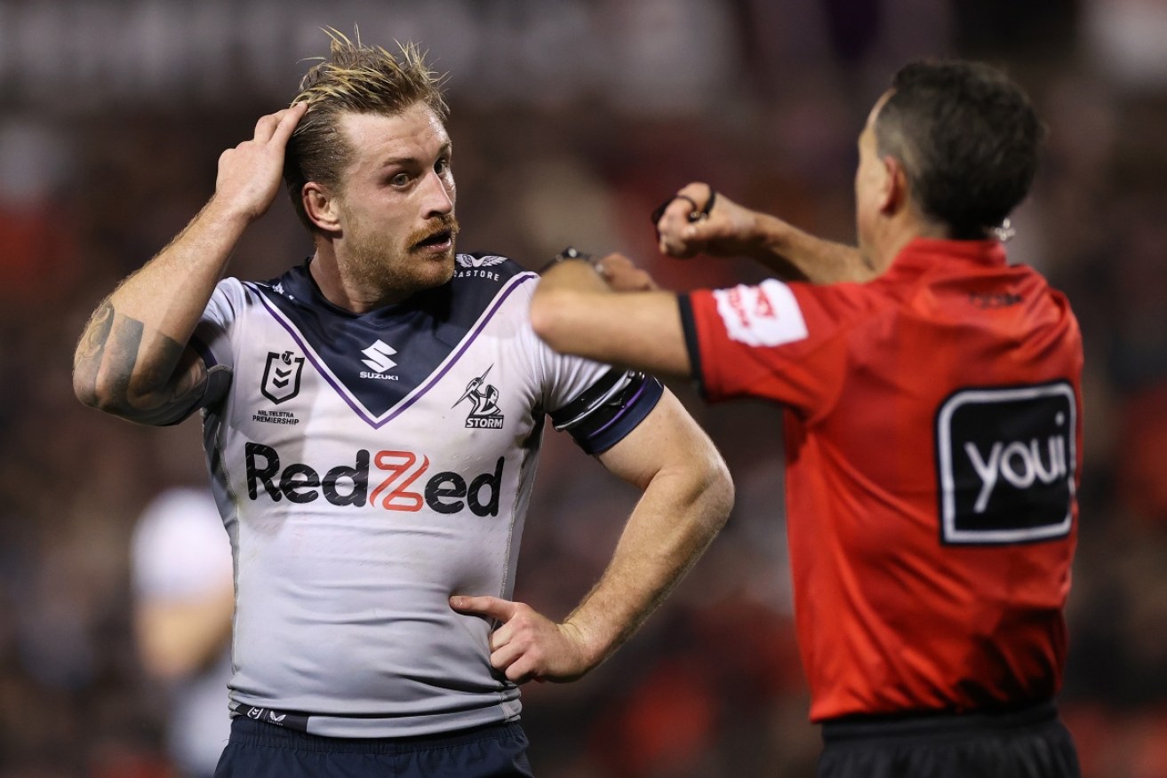 Cameron Munster reacts as referee Gerard Sutton signals 'tackled in the air' against Penrith on Thursday night.