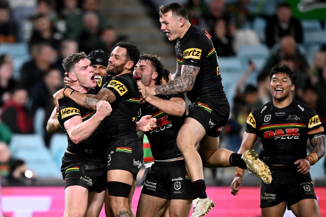 Liam Martin celebrates his match-winning try with teammates.