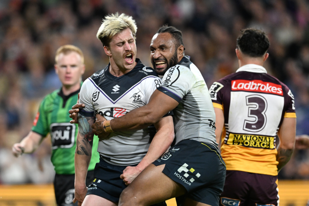 Cameron Munster (left) of the Storm celebrates a try with Justin Olam before returning to the task of running wild over the Broncos. <i>Photo: AAP</i>