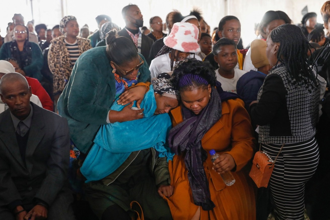 Relatives of the teenage night club victims mourning at their funeral.