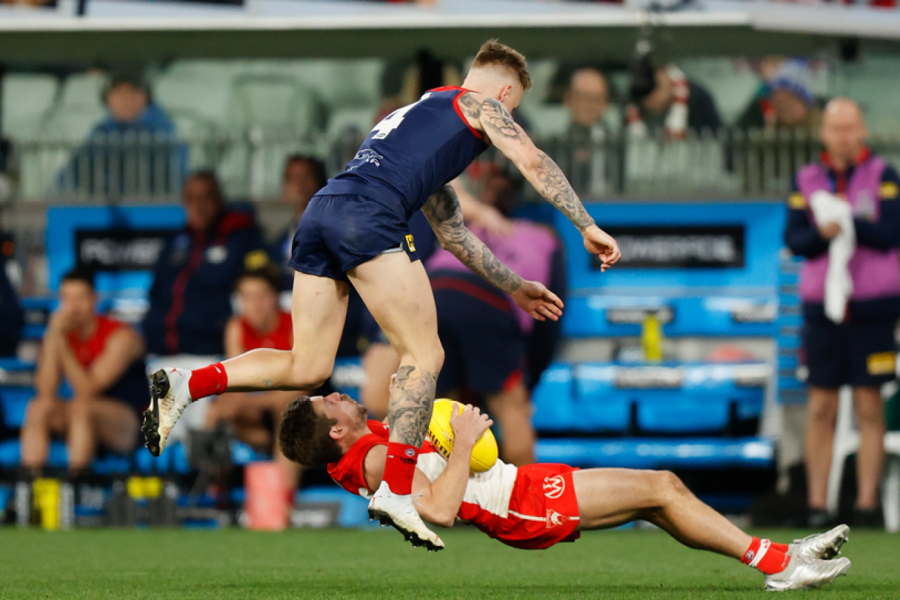 James Harmes knocks the wind out of the Swans' Jake and earns himself an encounter with the match review committee. <i>Photo: Getty</i>