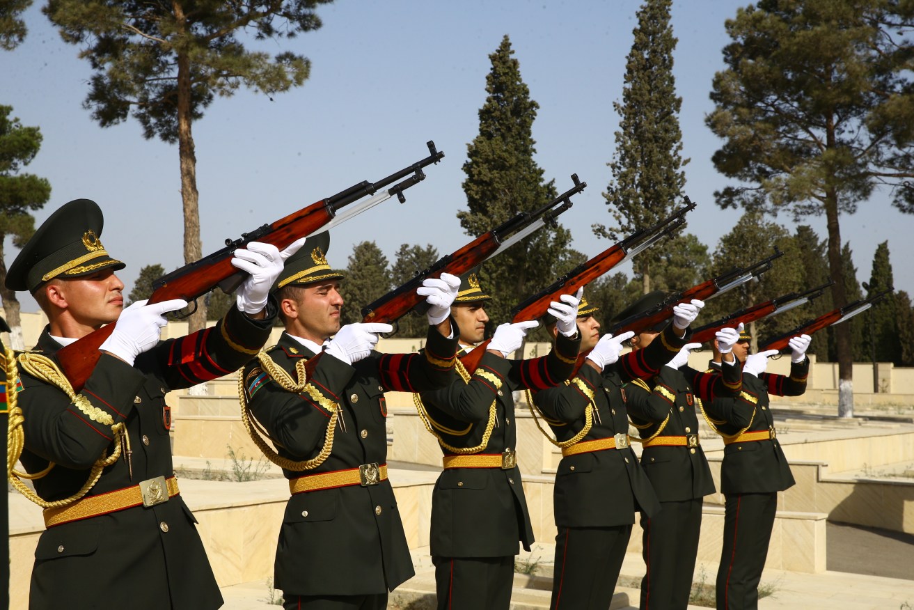 An Azerbaijan honour guard salute during a mass funeral for victims of border clashes with Armenia.