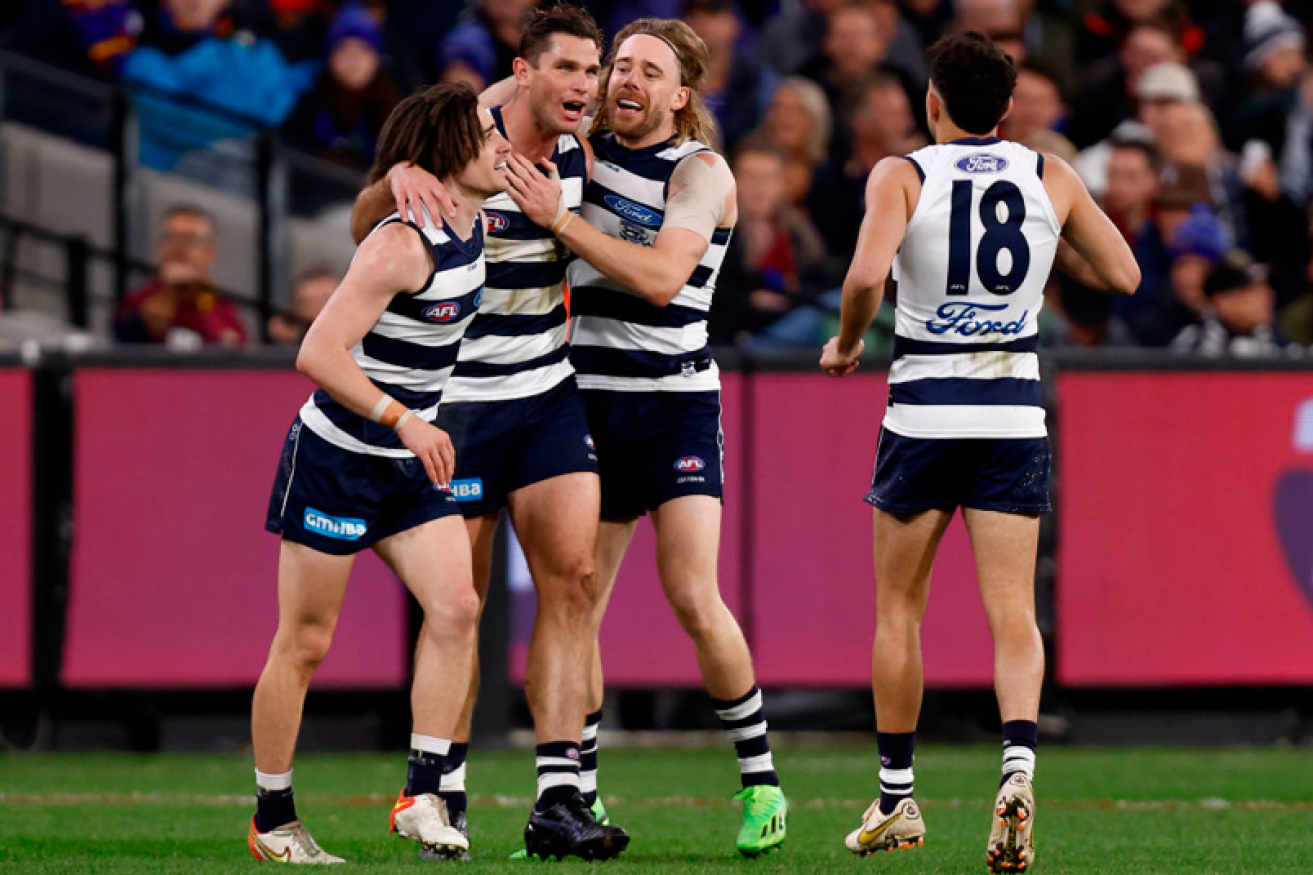 Teammates celebrate with Tom Hawkins after the veteran forward put another nail in the Lions' hopes. <i>Photo: Getty</I> 