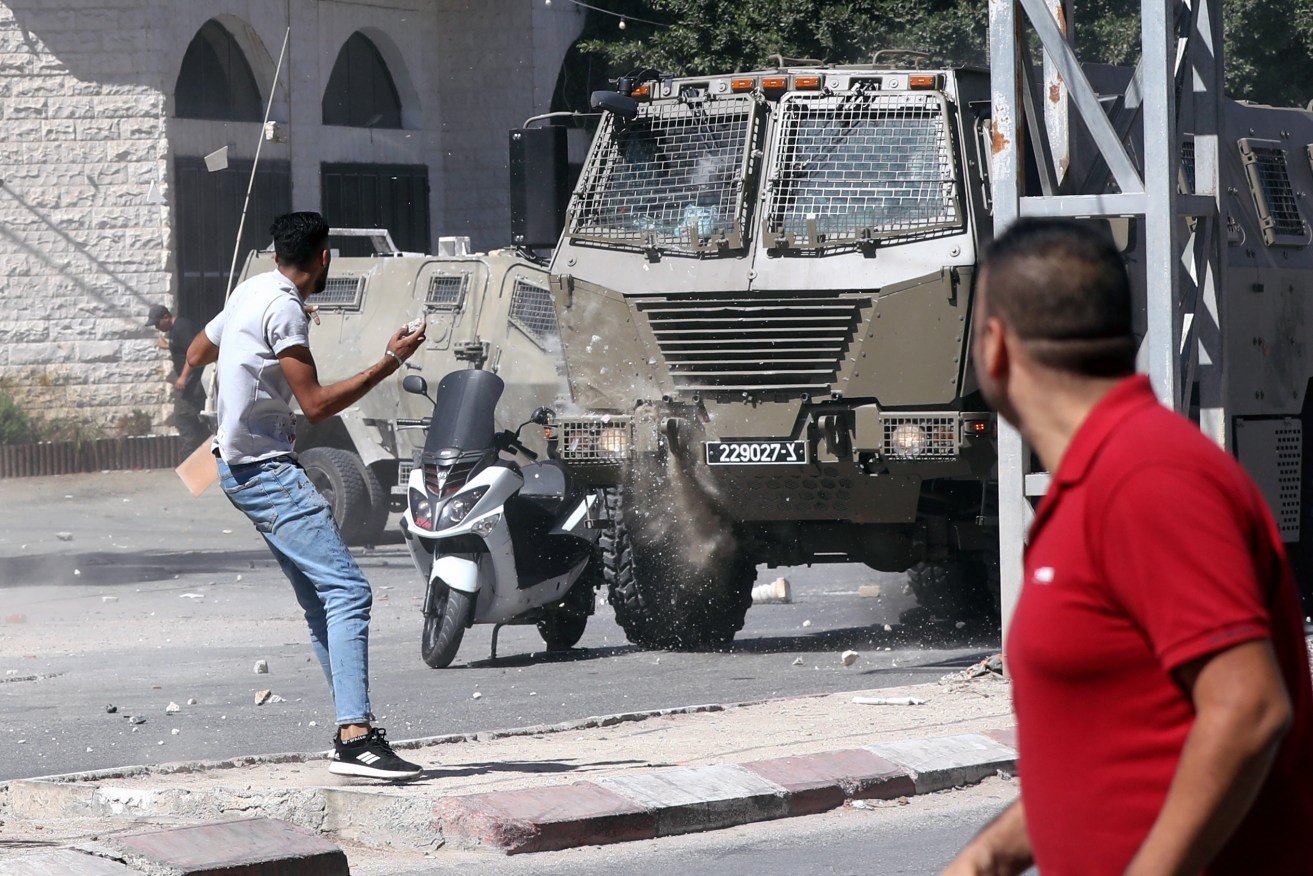 Palestinians clash with troops after Israeli forces conducted a raid in the West Bank city of Jenin.