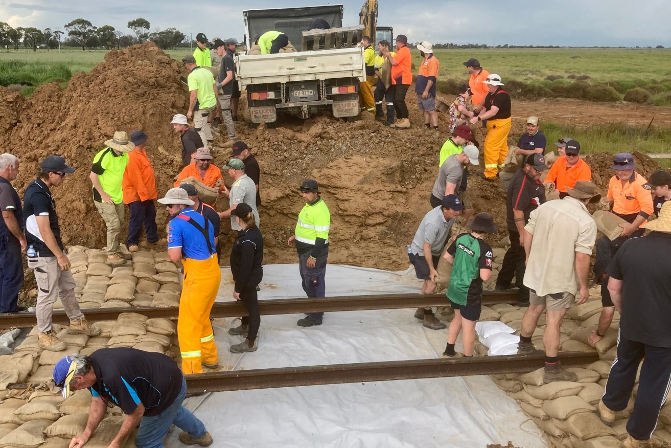 Kerang locals sandbag the railway line to Swan Hill as the Lodden River is due to peak this weekend.