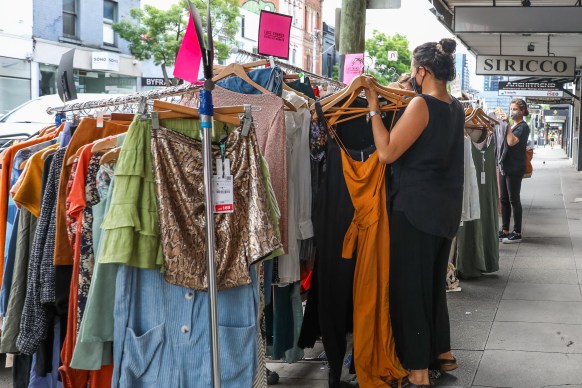 Retail shoppers are seen going through racks of clothes on sale on Chapel street in Melbourne
