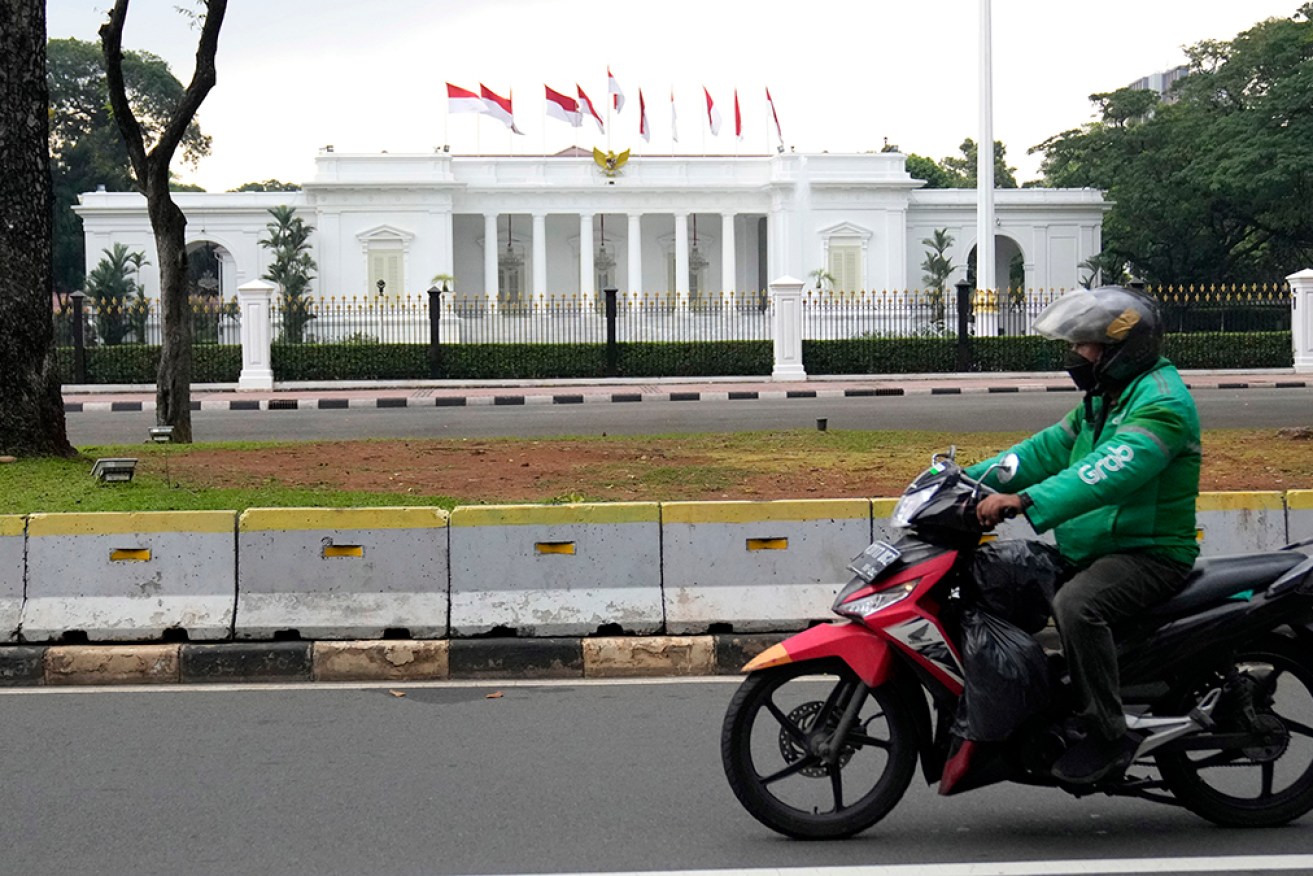 Indonesian police arrested a woman who pointed a gun at a presidential palace guard in Jakarta. 