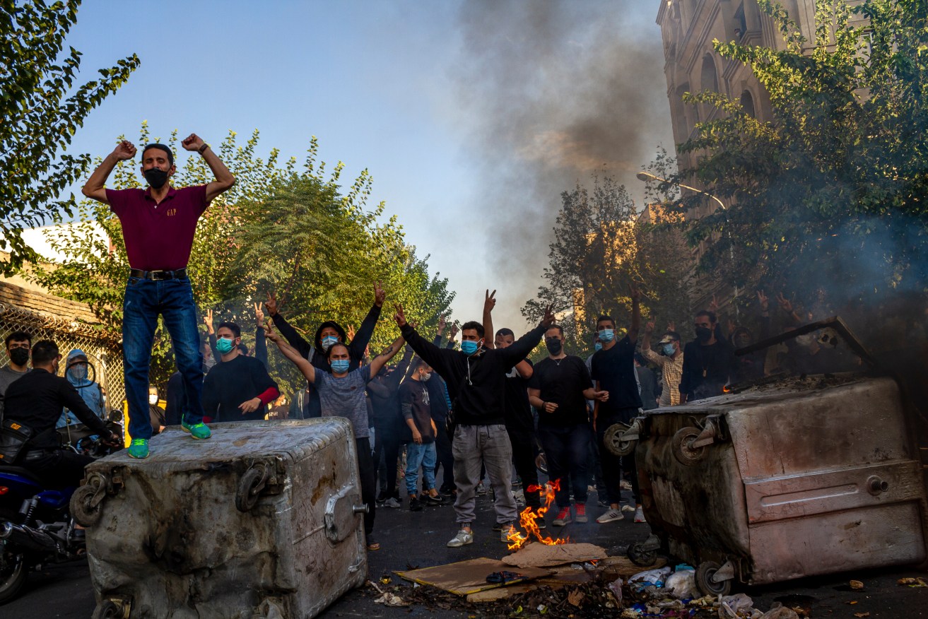 In this photo taken by an individual not employed by the Associated Press and obtained by the AP outside Iran, Iranians protests the death of 22-year-old Mahsa Amini after she was detained by the morality police last month, in Tehran, Thursday, Oct. 27, 2022. (AP Photo/Middle East Images, File)